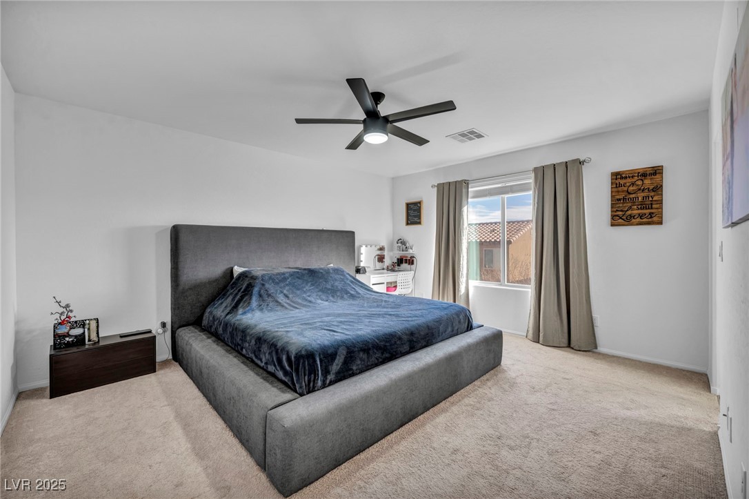 854 Earth Luster Road Las Vegas, NV 89178 - Photo 42 of 65 Bedroom featuring a ceiling fan, carpet, and visible vents