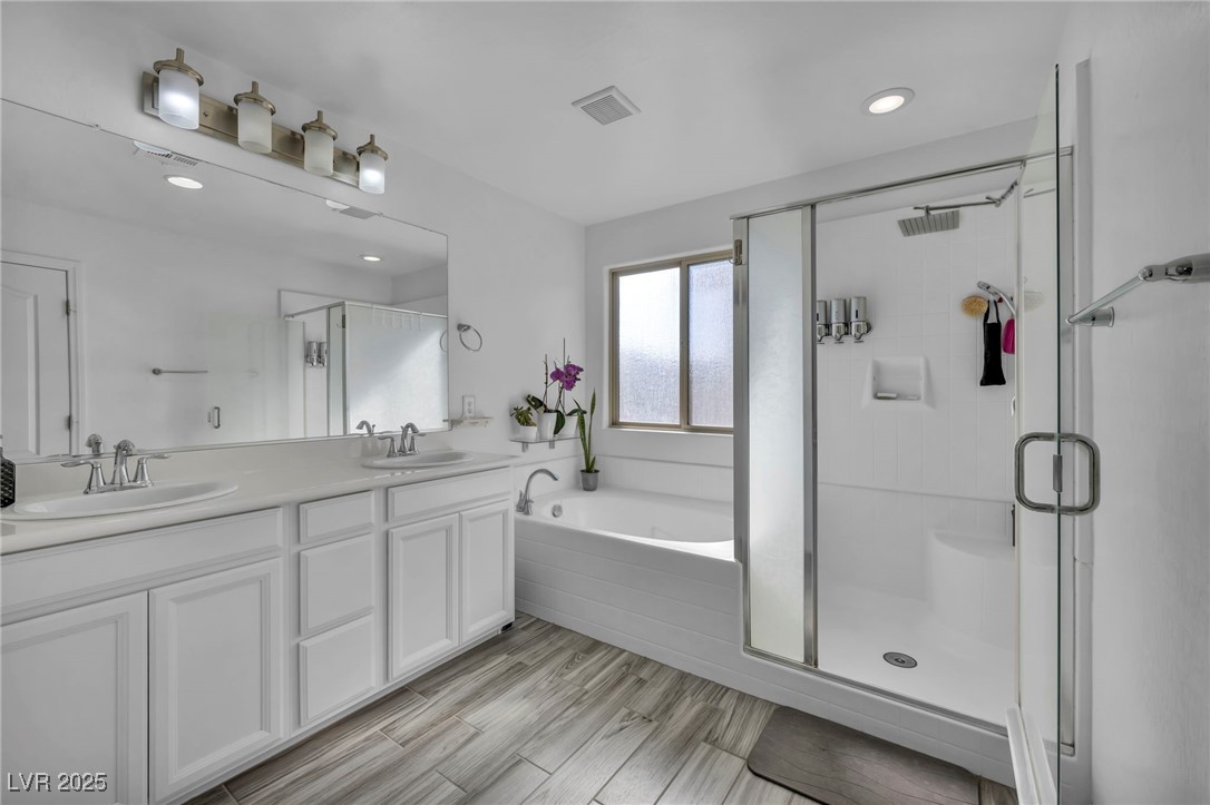854 Earth Luster Road Las Vegas, NV 89178 - Photo 45 of 65 Bathroom with a garden tub, a sink, a shower stall, and double vanity