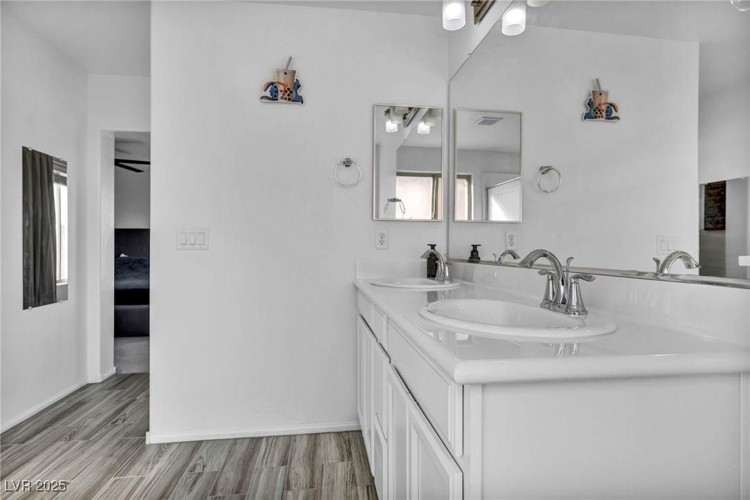 854 Earth Luster Road Las Vegas, NV 89178 - Photo 47 of 65 Bathroom featuring wood finished floors, ensuite bath, and a sink