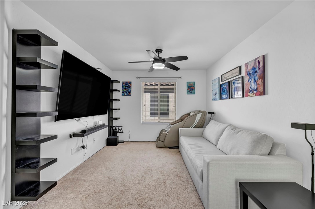 854 Earth Luster Road Las Vegas, NV 89178 - Photo 51 of 65 Living area featuring a ceiling fan and light colored carpet