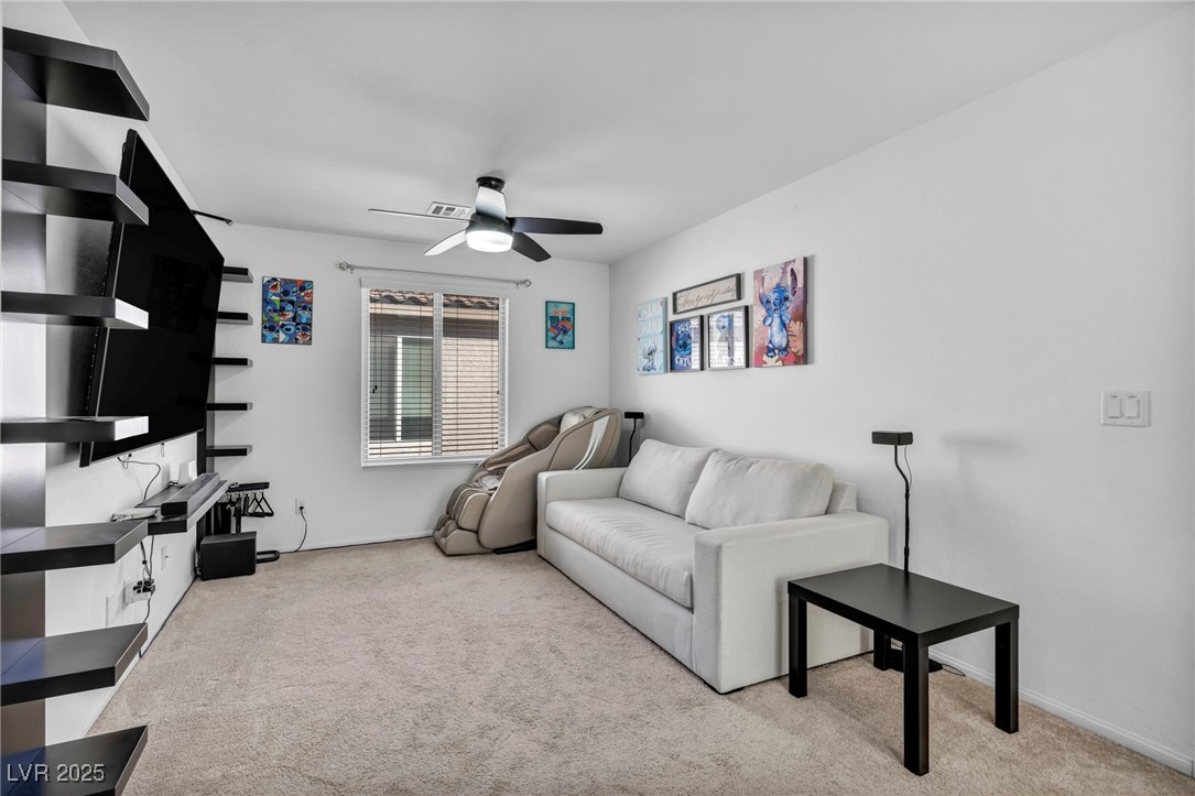 854 Earth Luster Road Las Vegas, NV 89178 - Photo 52 of 65 Living room featuring light carpet and ceiling fan