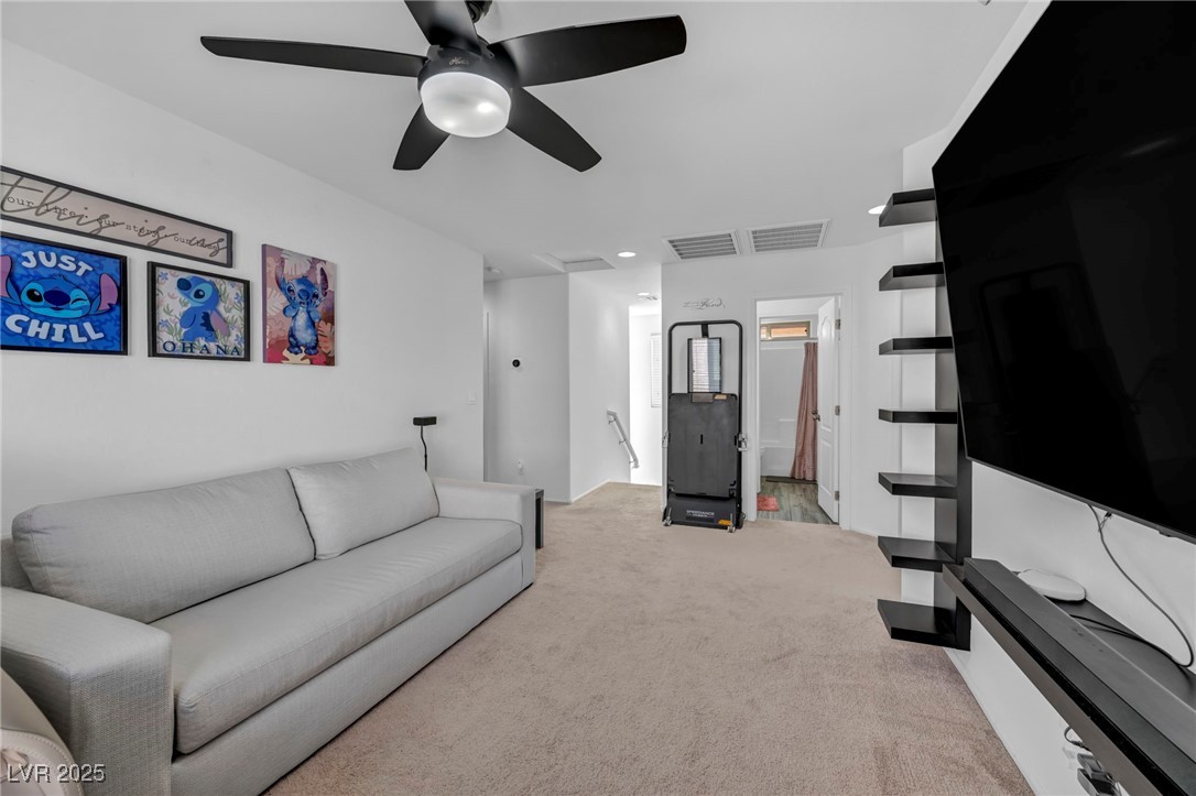 854 Earth Luster Road Las Vegas, NV 89178 - Photo 53 of 65 Living room with light carpet, ceiling fan, and visible vents