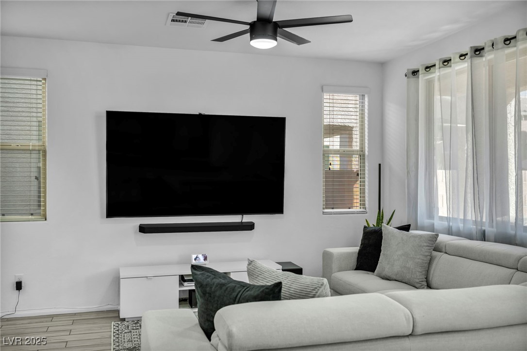 854 Earth Luster Road Las Vegas, NV 89178 - Photo 59 of 65 Living room with light wood-style floors, visible vents, and a ceiling fan