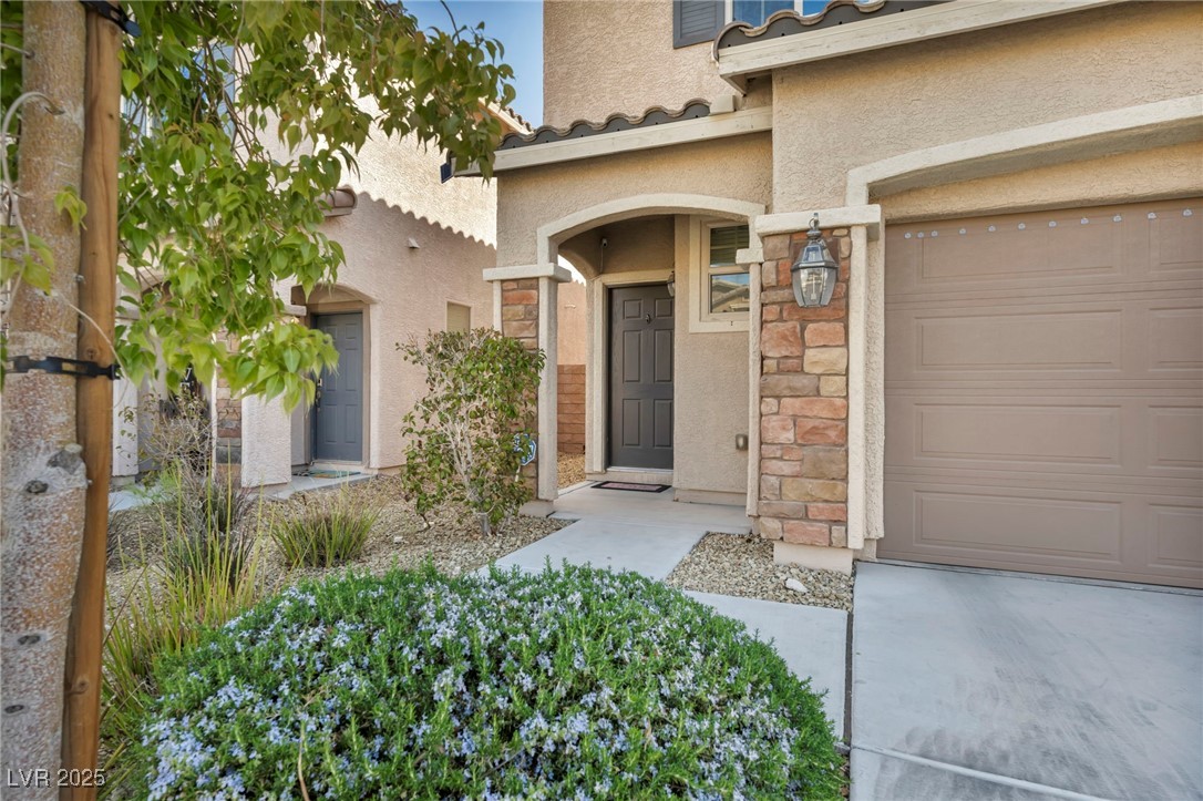 854 Earth Luster Road Las Vegas, NV 89178 - Photo 6 of 65 Entrance to property featuring stone siding and stucco siding