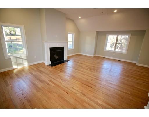 43 Bellflower Road Billerica, MA 01821 - Photo 4 of 13 a view of a livingroom with wooden floor and a fireplace