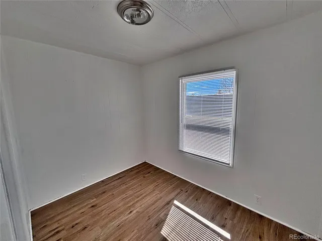 a room with a window and wooden floor