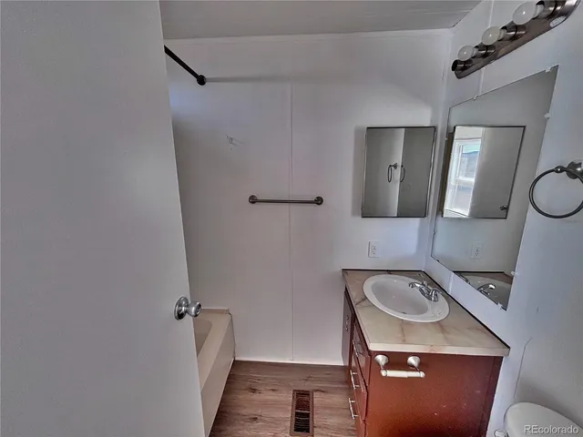 a bathroom with a sink a toilet and mirror