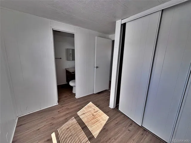 a view of an empty room and wooden floor