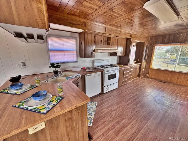 a kitchen with a sink appliances and cabinets