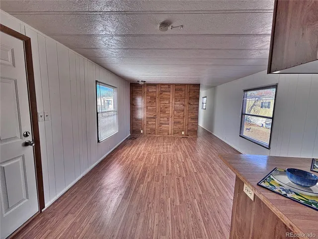a view of empty room with wooden floor