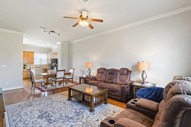 a living room with furniture a rug and a chandelier