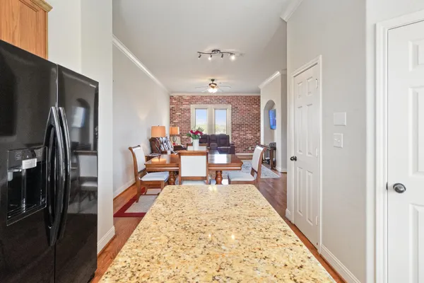 a living room with furniture flat screen tv and a table