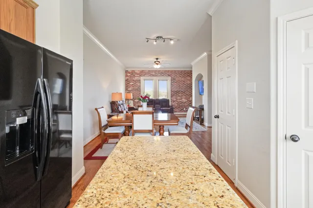 a living room with furniture flat screen tv and a table