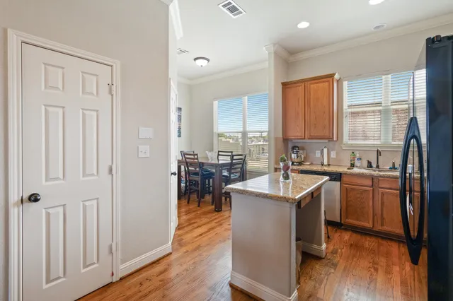 a kitchen with stainless steel appliances granite countertop a sink stove and wooden floor