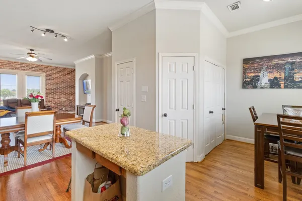 a living room with dining table and wooden floor