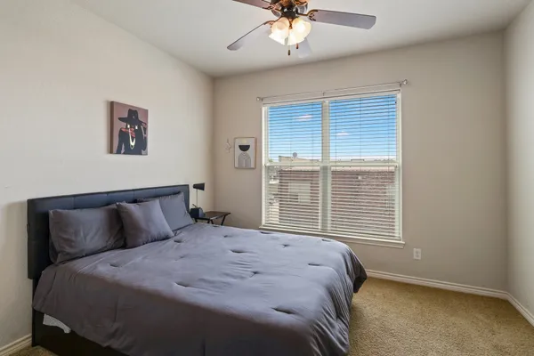 a bedroom with a large bed and a window