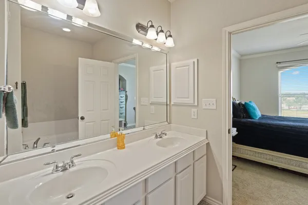 a bathroom with a sink double vanity and a mirror