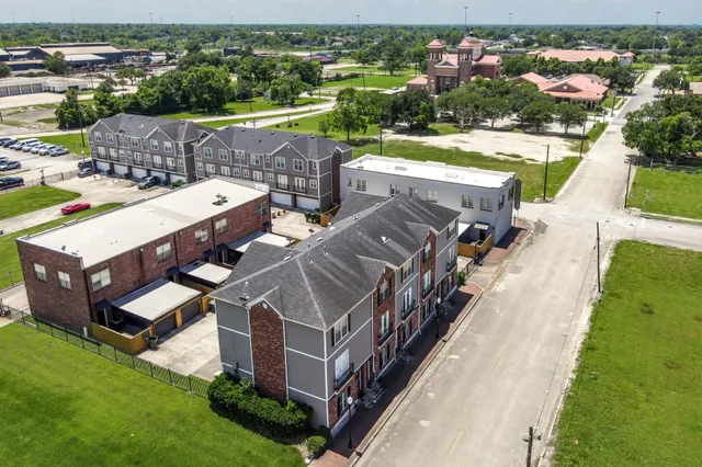 an aerial view of a house with swimming pool and garden view
