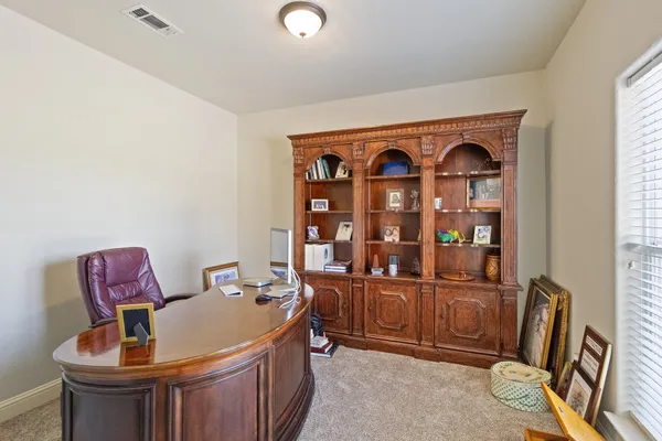 a view of a room that has a couch and a workspace