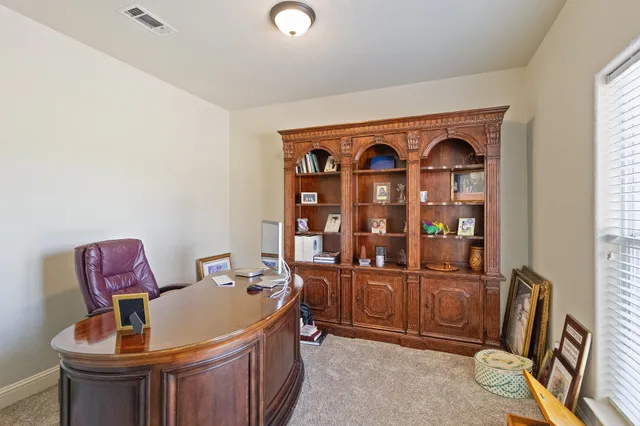 a view of a room that has a couch and a workspace