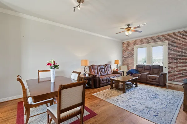a living room with furniture and wooden floor