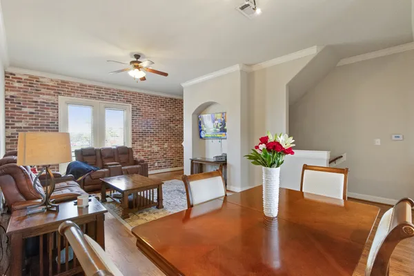 a living room with furniture dining table a chandelier and a piano