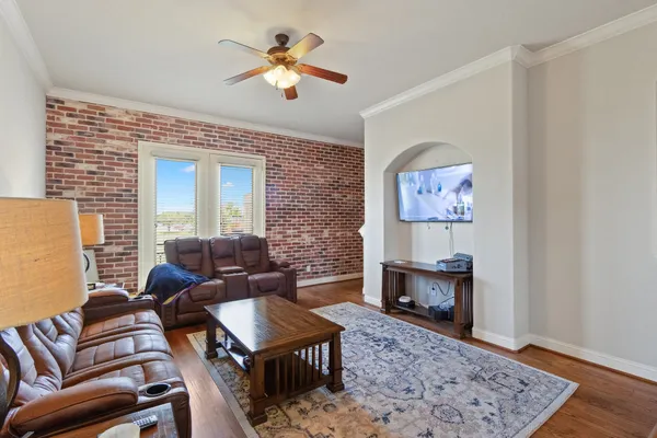 a living room with furniture and a wooden floor