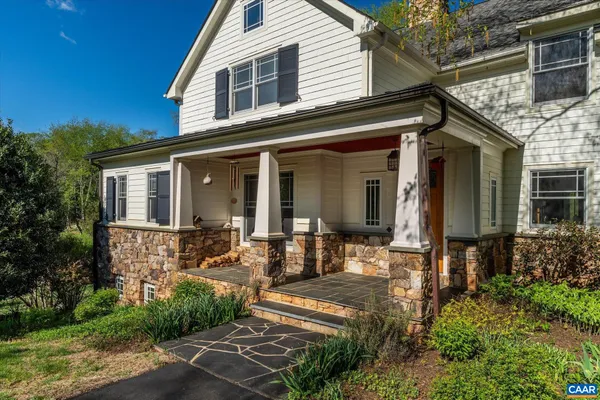 a large kitchen with granite countertop a large counter top appliances and cabinets