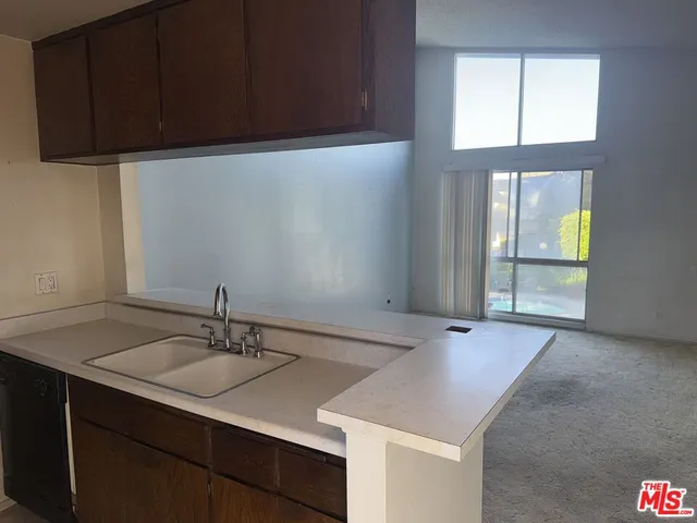 an empty room with a fireplace and wooden floor