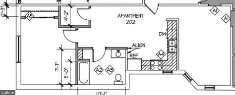 a street sign on a wall next to a white house