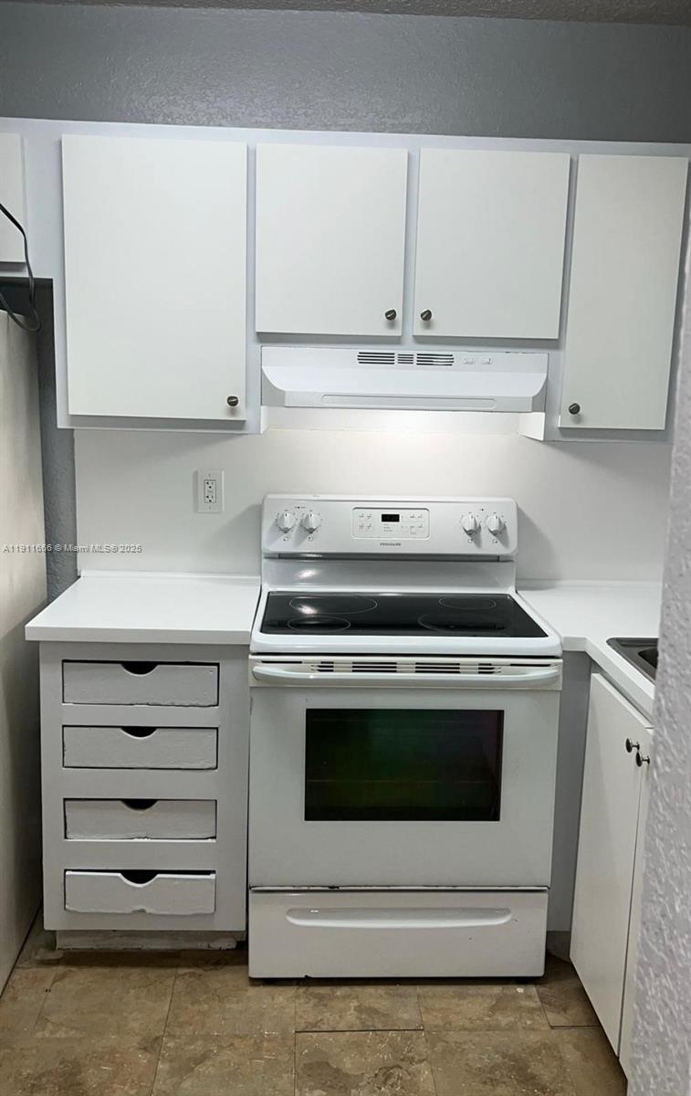 575 West 69th Street, Unit 208 Hialeah, FL 33014 - Photo 5 of 10 a stove top oven sitting inside of a kitchen