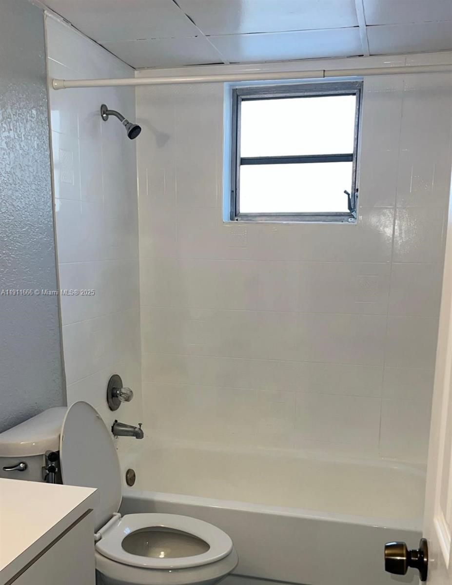 575 West 69th Street, Unit 208 Hialeah, FL 33014 - Photo 9 of 10 a bathroom with a granite countertop bathtub sink vanity and toilet