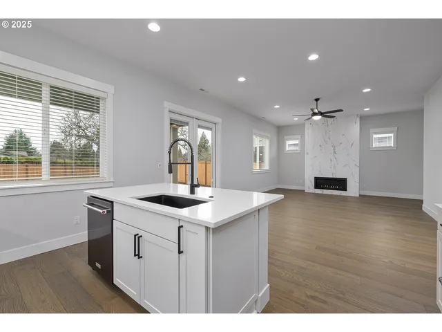 a kitchen with a stove a sink a refrigerator and a window