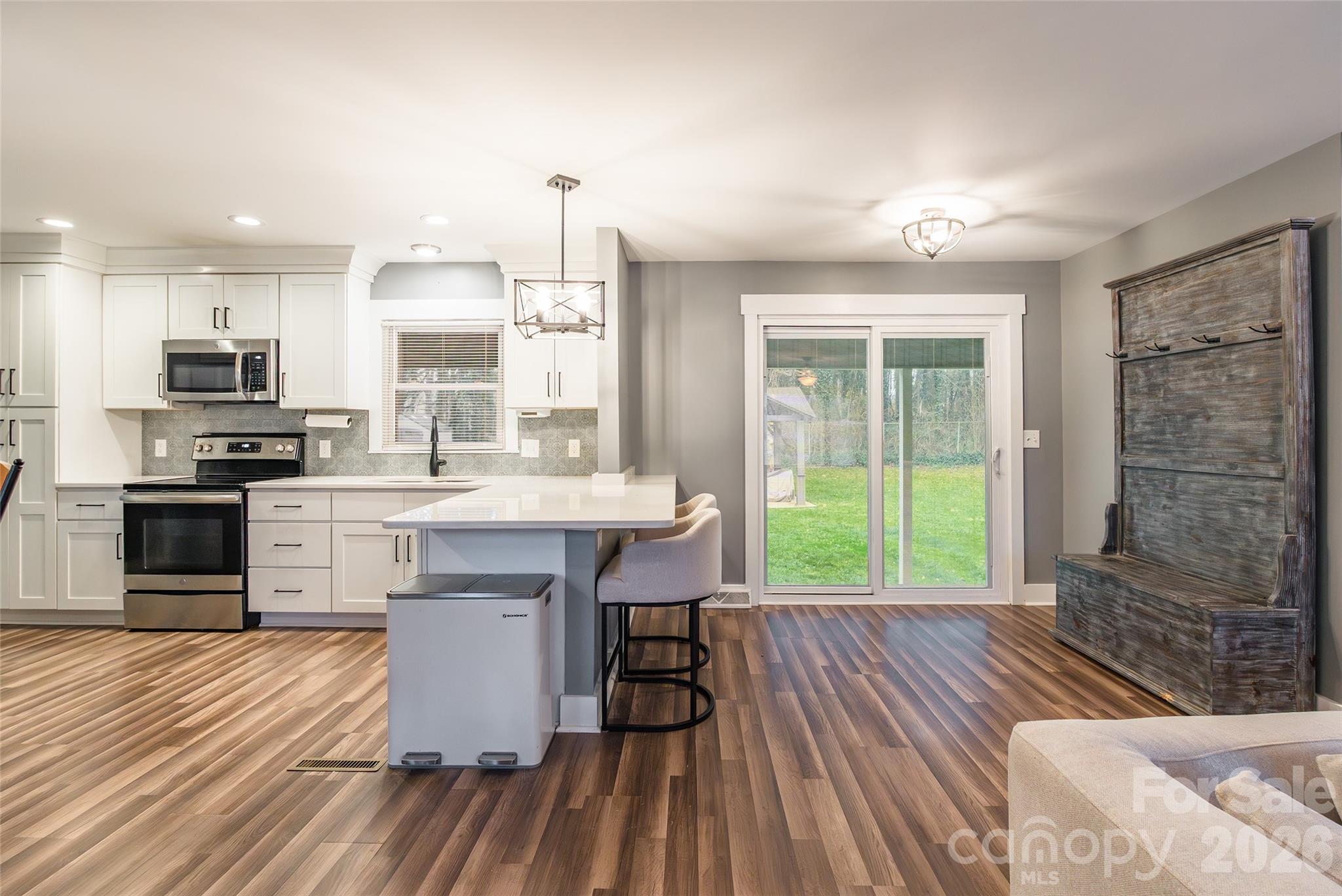 245 Mellon Road Belmont, NC 28012 - Photo 3 of 30 a kitchen with kitchen island granite countertop a stove a sink and a refrigerator
