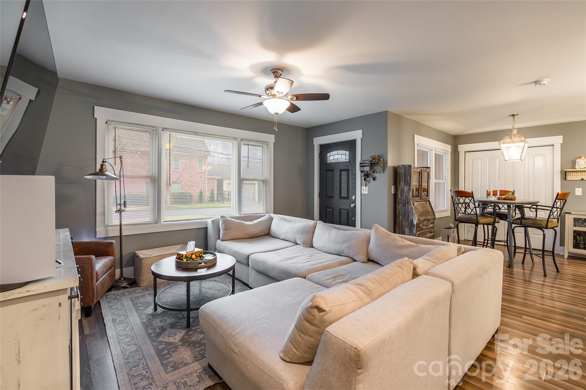 245 Mellon Road Belmont, NC 28012 - Photo 4 of 30 a living room with furniture and a dining table with wooden floor