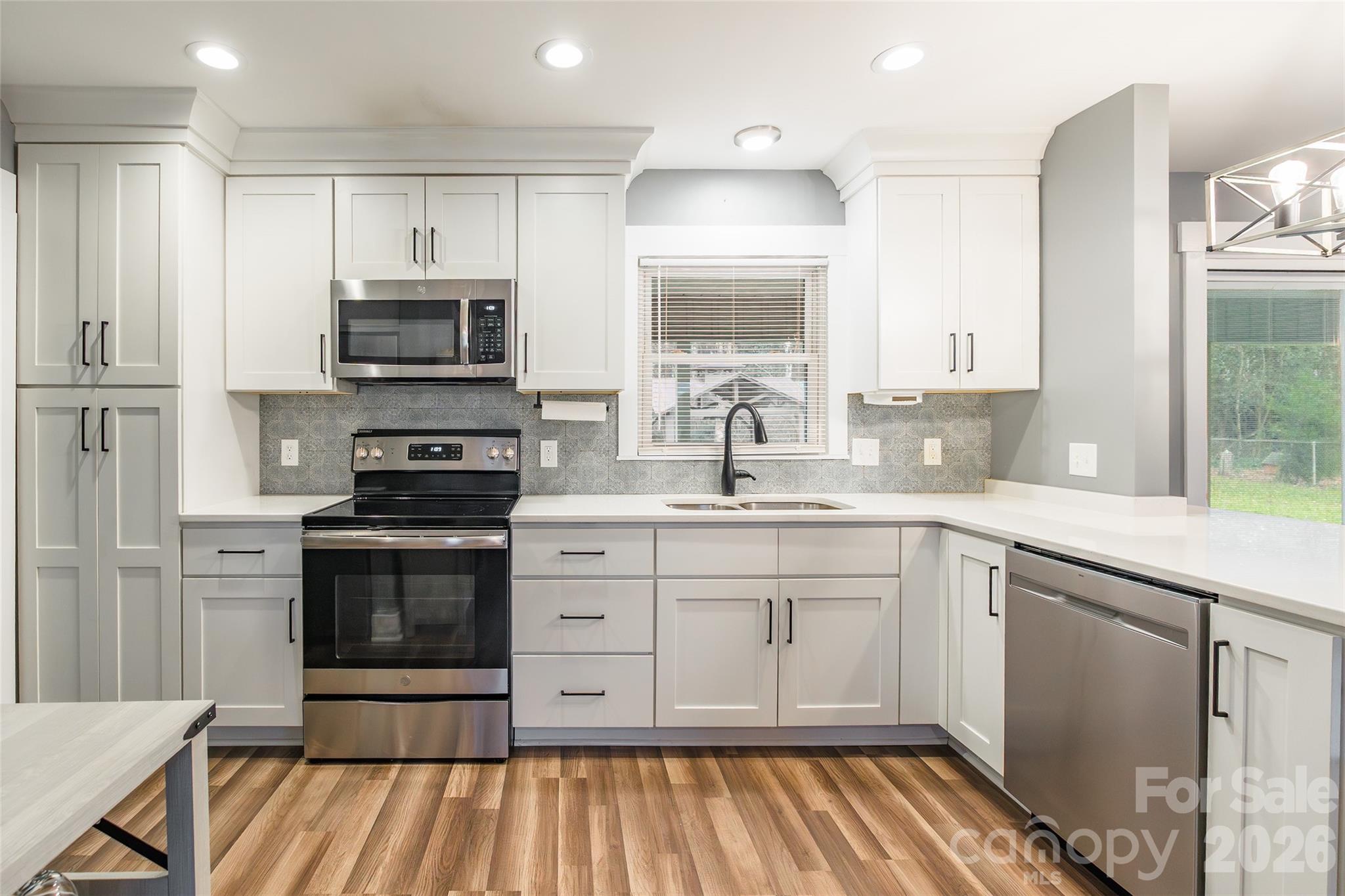 245 Mellon Road Belmont, NC 28012 - Photo 9 of 30 a kitchen with stainless steel appliances a stove sink and microwave