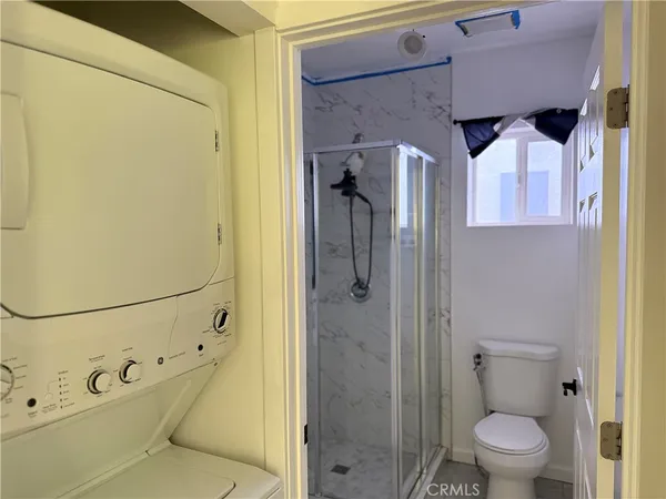 a bathroom with a toilet and a shower