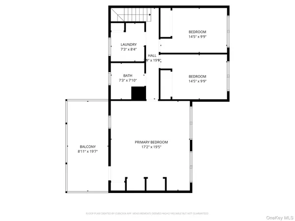 a picture of a bench in front of a wall