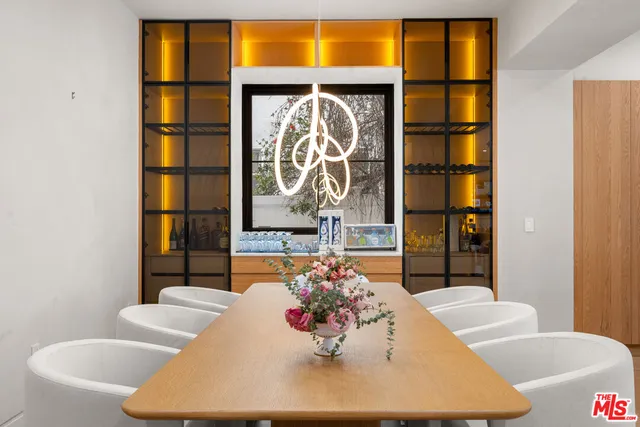 a view of kitchen with stainless steel appliances granite countertop sink and a refrigerator