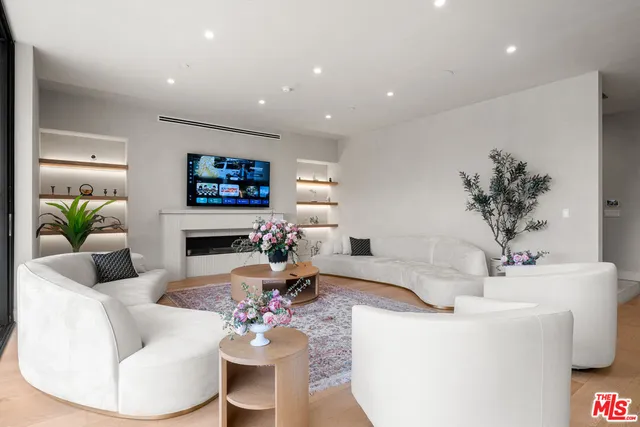 a dining room with stainless steel appliances kitchen island granite countertop a table and chairs