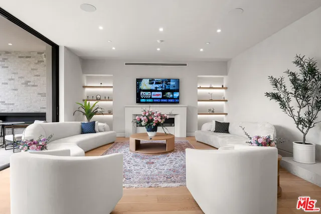 a dining room filled chandelier and wooden floor