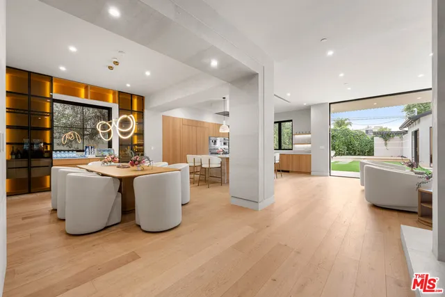a bathroom with a granite countertop sink a toilet and mirror