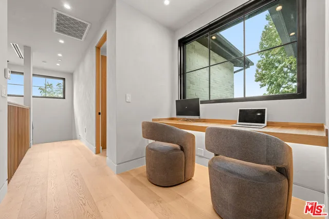 a bathroom with a granite countertop sink a toilet a mirror and shower