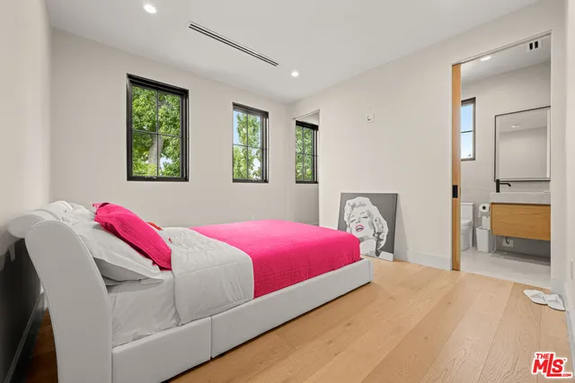 a view of roof deck with wooden fence and trees
