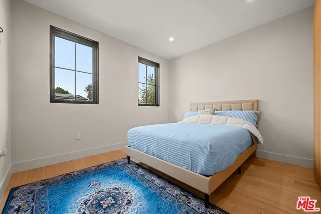 a view of a hallway with wooden floor and fence