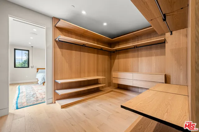 a en suite bathroom with a sink and a large mirror