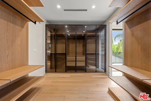 a bathroom with a double vanity sink a mirror and shower