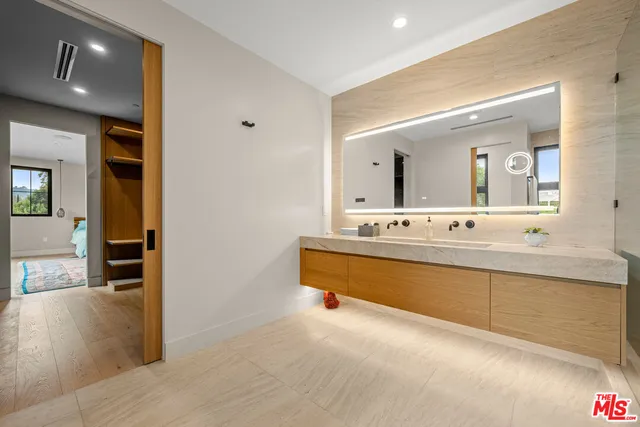 a view of a patio with table and chairs with wooden floor and fence