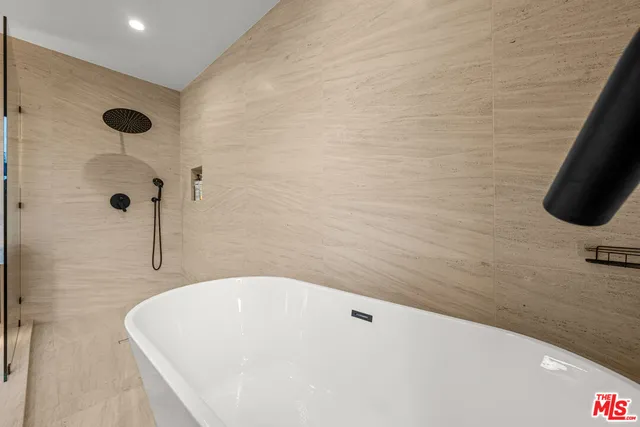 a patio with a table and chairs and plants