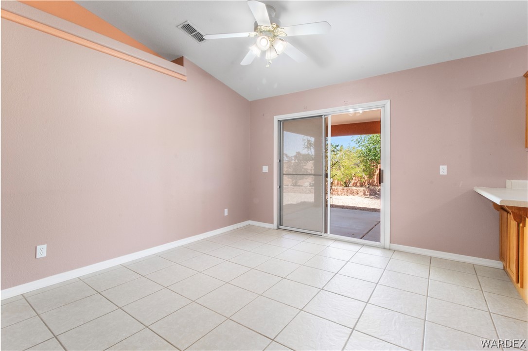 2158 Ranch Road Kingman, AZ 86401 - Photo 12 of 48 a view of an empty room and window with a kitchen